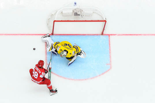 Alan Lyszczarczyk of Poland and goaltender Filip Gustavsson