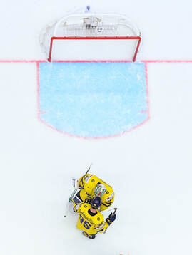 Goaltender Filip Gustavsson and André Burakovsky celebrate