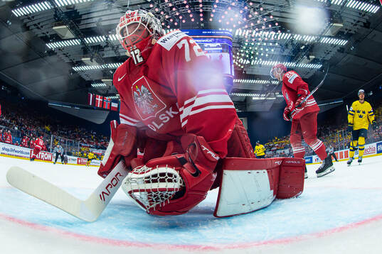 Goaltender David Zabolotny of Poland looks dejected
