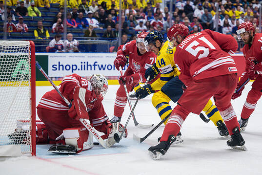 Goaltender David Zabolotny of Poland and Joel Eriksson Ek
