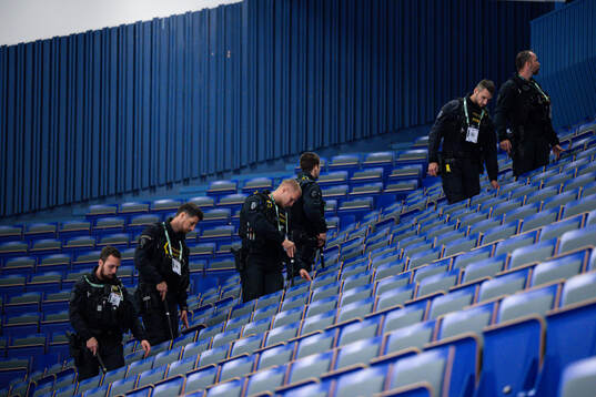 The police search the arena for suspicious objects