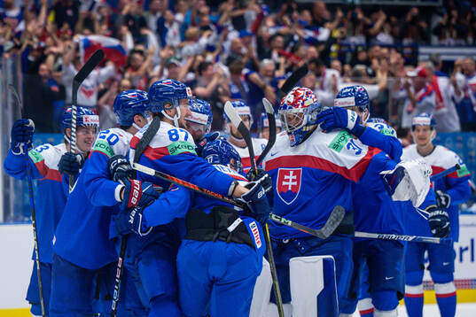 Goaltender Samuel Hlavaj of Slovakia celebrate with teammate