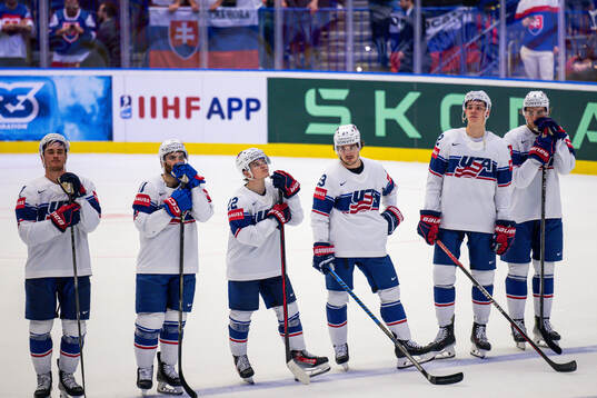 Luke Kusin, Matt Boldy and Michael Eyssimont of USA look
