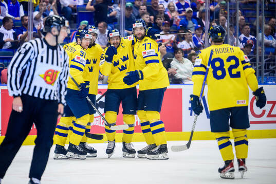 Erik Karlsson and Victor Hedman of Sweden celebrate