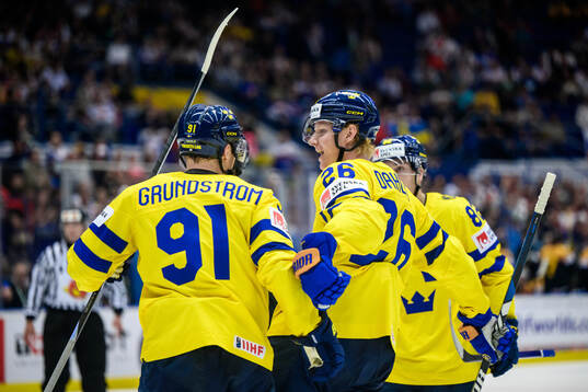Carl Grundström and Rasmus Dahlin of Sweden celebrate