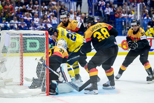 Rasmus Dahlin of Sweden and goaltender Philipp Grubauer of