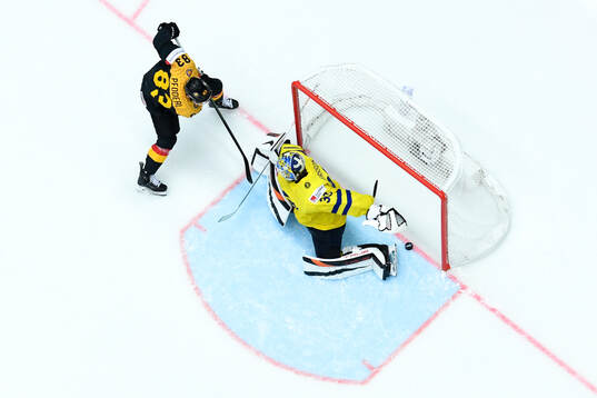 Leonhard Pfoderl of Germany and goaltender Samuel Ersson of
