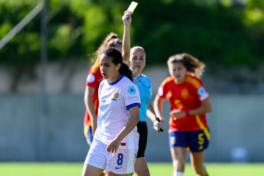 Ambre Ouazar of France receives a yellow card