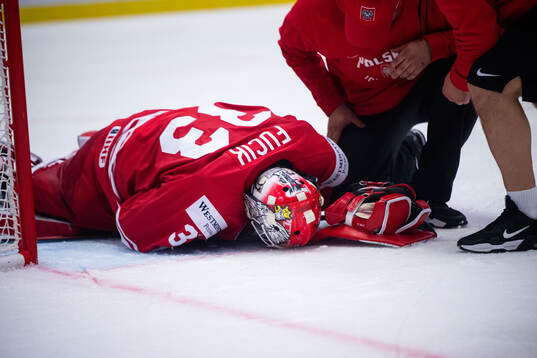 Goaltender Tomas Fucik of Poland in pain