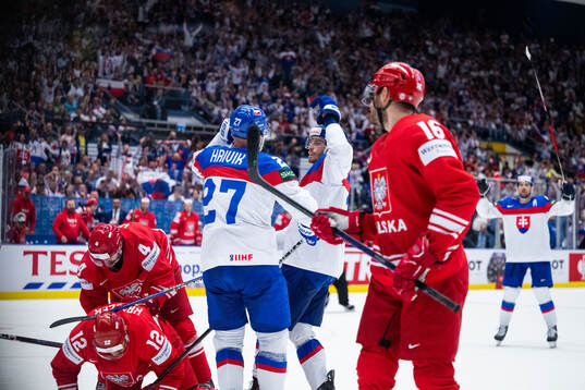 Marek Hrivik of Slovakia celebrates with Peter Cehlarik