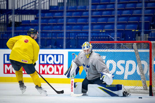 Max Friberg and goaltender Jesper Wallstedt of Sweden at a