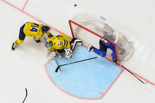 Joel Eriksson Ek, goaltender Samuel Ersson of Sweden and