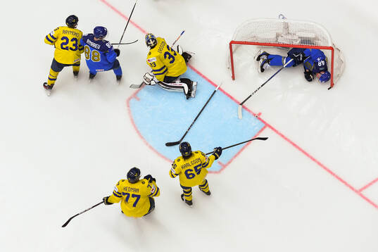 Goaltender Samuel Ersson of Sweden and Roman Starchenko of