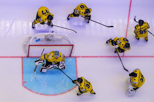 Goaltender Samuel Ersson of Sweden with teammates