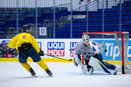 Max Friberg and goaltender Jesper Wallstedt of Sweden at a
