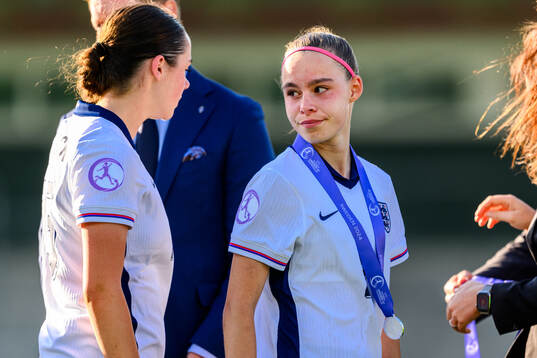 Nelly Las of England looks dejected