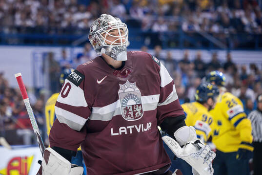 goaltender Elvis Merzlikins of Latvia looks dejected