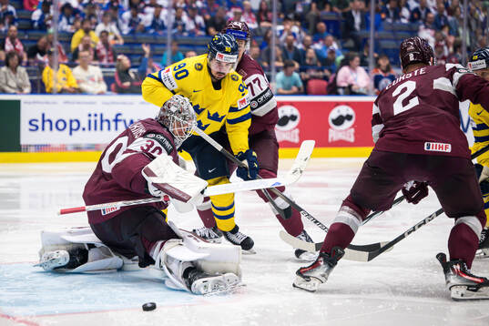 Marcus Johansson of Sweden and goaltender Elvis Merzlikins
