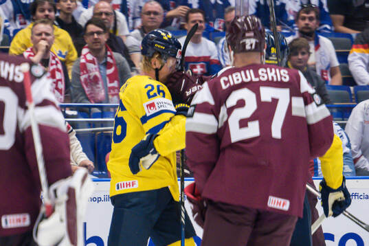 Rasmus Dahlin of Sweden is hit in the face