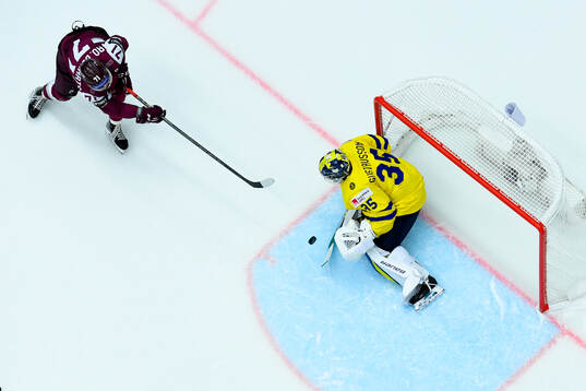 Roberts Bukarts of Latvia and goaltender Filip Gustavsson