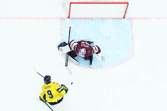 Adrian Kempe of Sweden and goaltender Kristers Gudlevskis