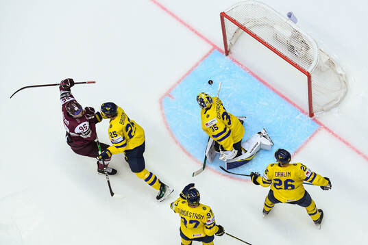 Oskars Batna celebrates the 2-2 goal behind goaltender