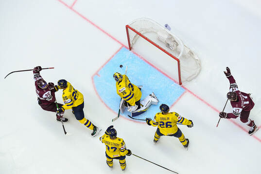 Oskars Batna celebrates the 2-2 goal behind goaltender