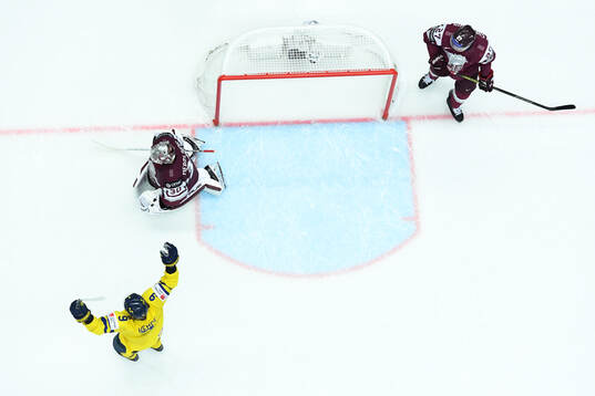 Adrian Kempe of Sweden celebrates and goaltender goaltender
