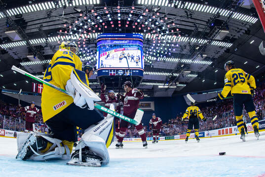 Oskars Batna celebrates the 2-2 goal behind goaltender