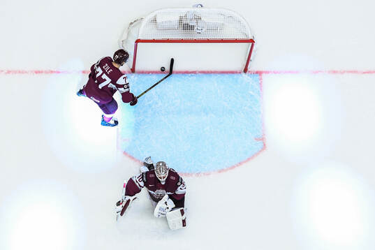 Goaltender Elvis Merzlikins and Roberts Kristaps Zile of