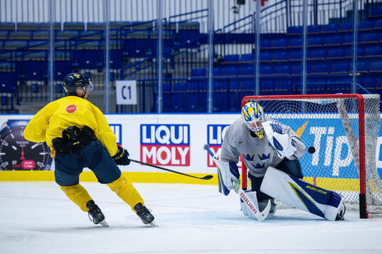 Max Friberg and goaltender Jesper Wallstedt of Sweden at a