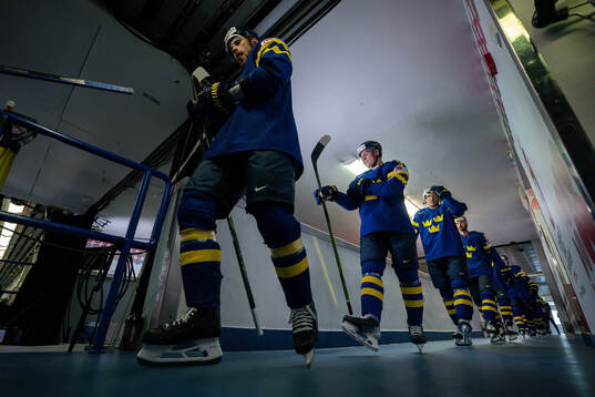 Players of Sweden enter the ice