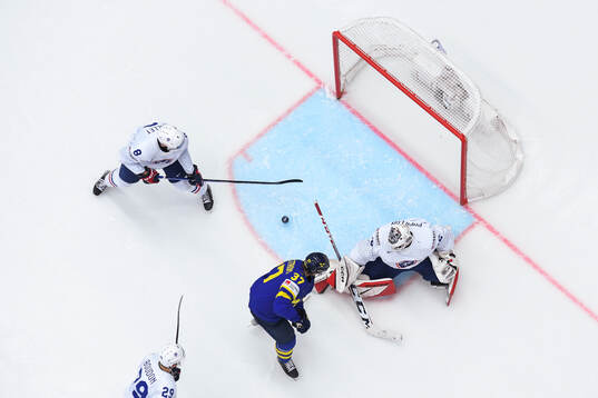 Isac Lundeström of Sweden and goaltender Quentin Papillon