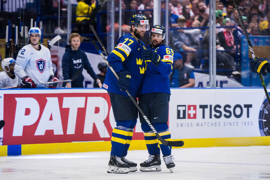 Victor Hedman and Erik Karlsson of Sweden celebrate