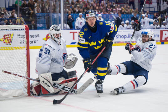 Max Friberg of Sweden against goaltender Quentin Papillon