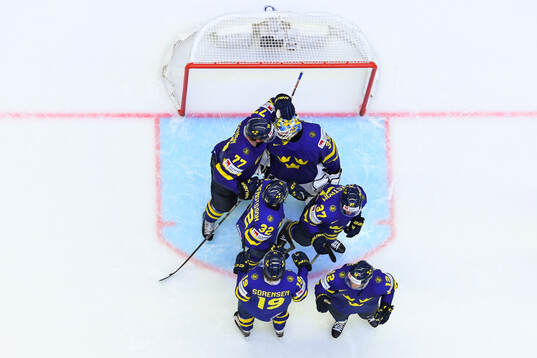 Goaltender Samuel Ersson celebrate with team mates