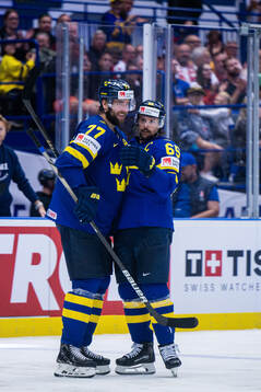 Victor Hedman and Erik Karlsson of Sweden celebrates the