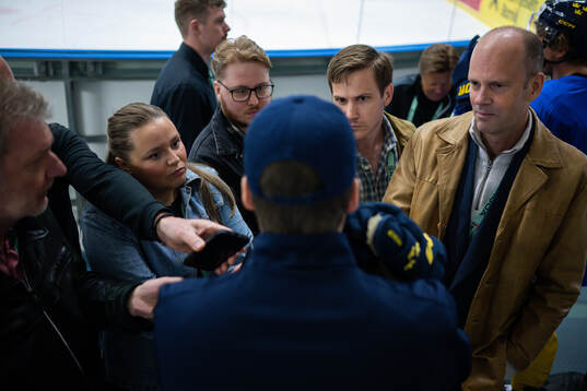 Head coach Sam Hallam of Sweden speaks with members of the