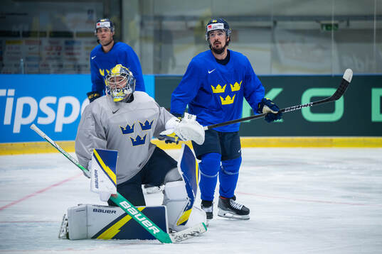 Goaltender Filip Gustavsson and Marcus Johansson of Sweden
