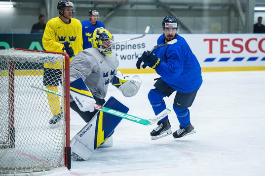 Goaltender Filip Gustavsson and Marcus Johansson of Sweden