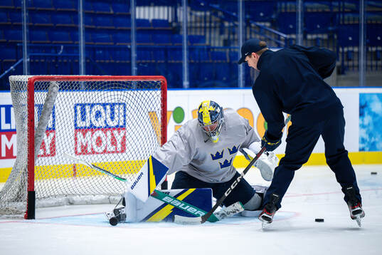 Goaltender Filip Gustavsson and goaltender coach Anthon