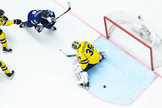 Hannes Björninen of Finland and goaltender Filip