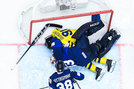 Goaltender Emil Larmi of Finland and Carl Grundström of
