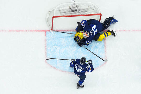 Carl Grundström of Sweden and goaltender Emil Larmi of