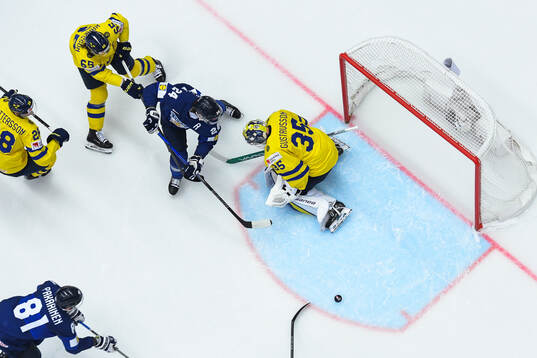Hannes Björninen of Finland and goaltender Filip