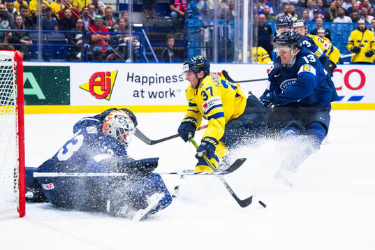 Goaltender Emil Larmi of Finland and Isac Lundeström of