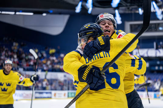 Lucas Raymond and Rasmus Dahlin of Sweden celebrate the 1-0