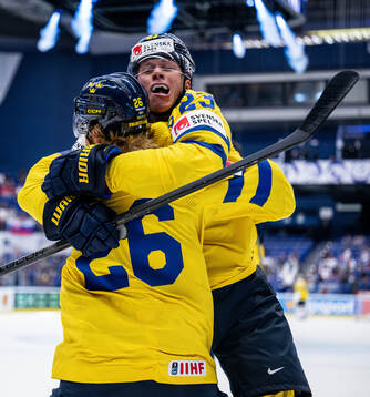 Lucas Raymond and Rasmus Dahlin of Sweden celebrate the 1-0