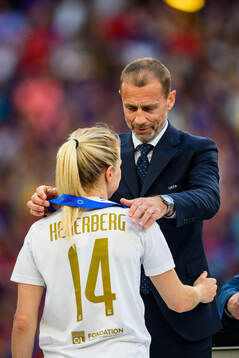 UEFA president Aleksander Ceferin hands Ada Hegerberg of