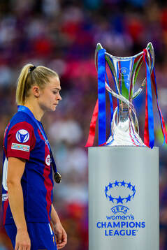 Fridolina Rolfö of Barcelona walks behind the trophy